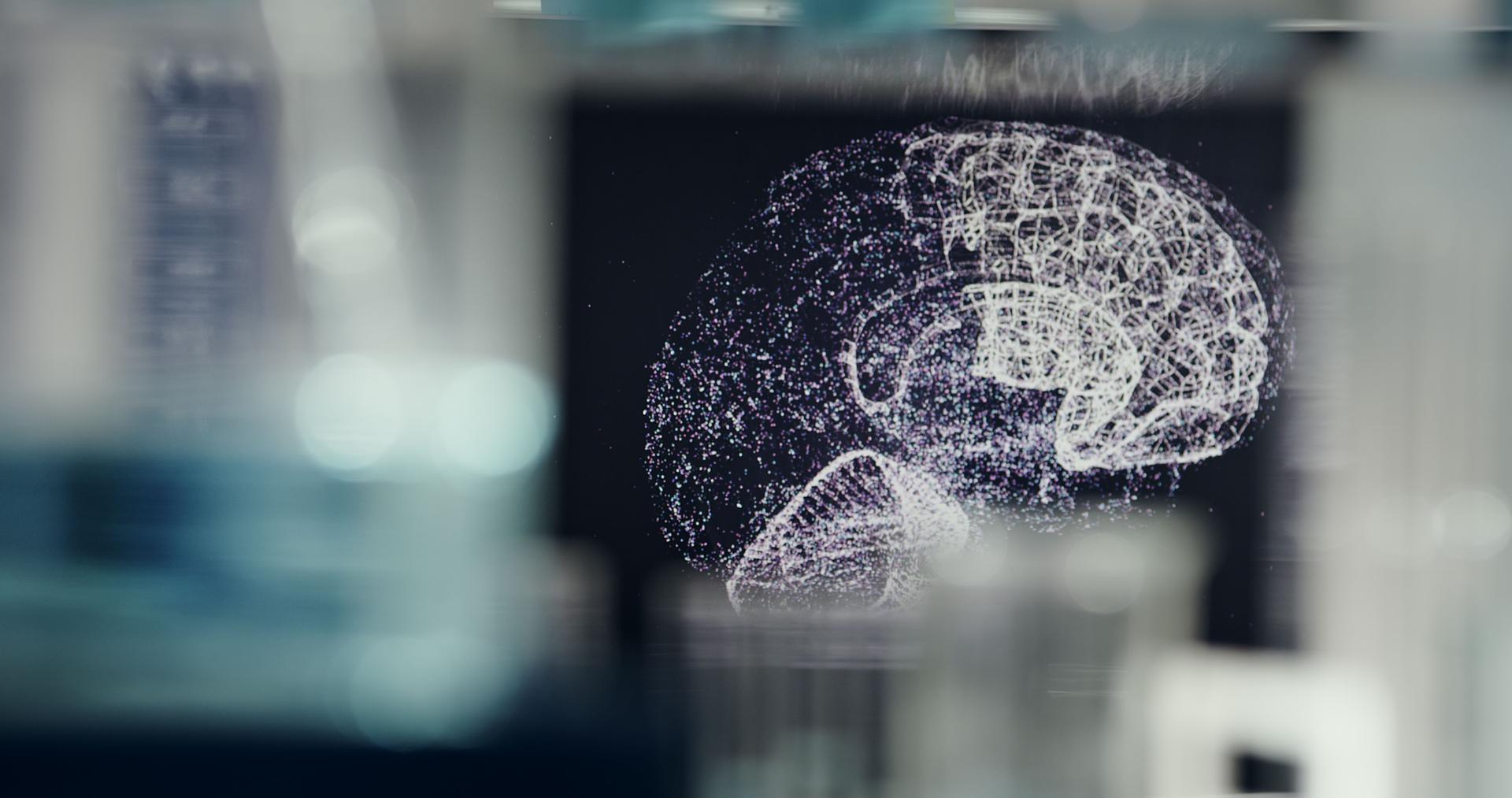 Laboratory equipment, microscope and computers. Brain models on screens. Rear view of scientist